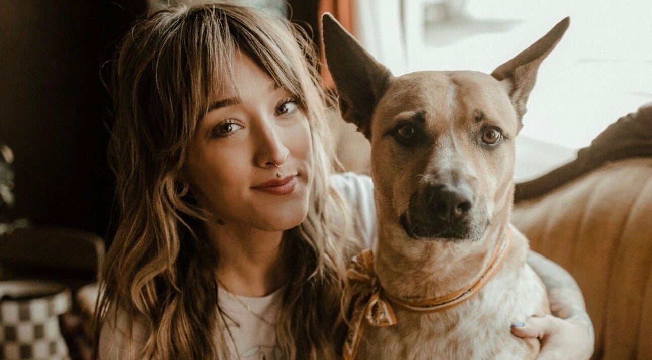A person with a dog at Third Hand Salon, Rock Island, Illinois, US, showcasing a welcoming atmosphere.