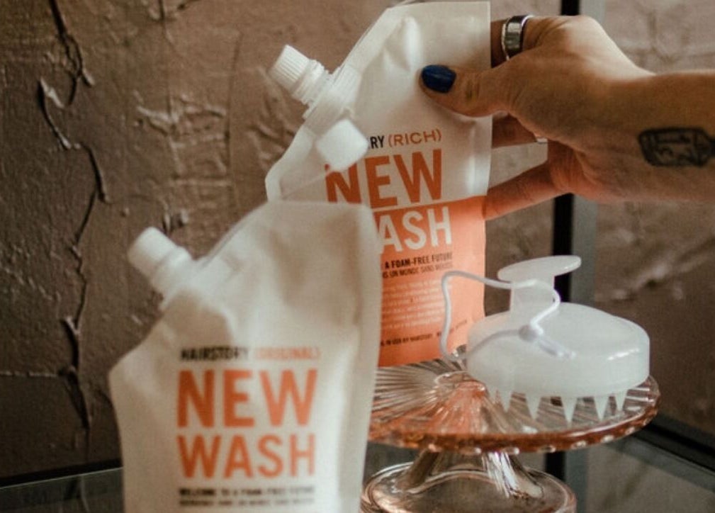 Hand arranging eco-friendly hair wash at Third Hand Salon, Rock Island, Illinois, US.