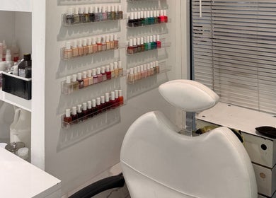 Nail polish display at Bleu Ciel spa, New York, New York, US. Modern, chic manicure station with white chair.