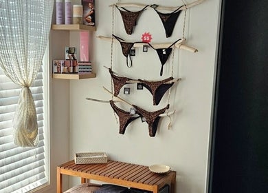 Stylish tanning room at Beachbums Tanning & Hair Bribie, Bongaree, Queensland, AU with displayed beachwear.