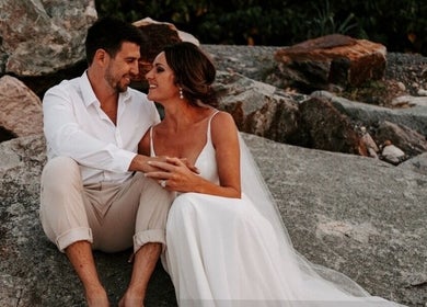 Couple enjoying a romantic moment on rocks at Beachbums Tanning & Hair Bribie, Bongaree, Queensland, AU.