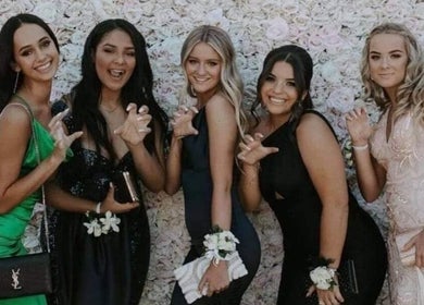 Friends posing in elegant dresses at Beachbums Tanning & Hair Bribie in Bongaree, Queensland, AU.