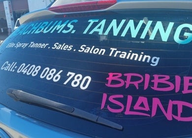 Beachbums Tanning & Hair Bribie car signage showcasing services in Bongaree, Queensland, AU.