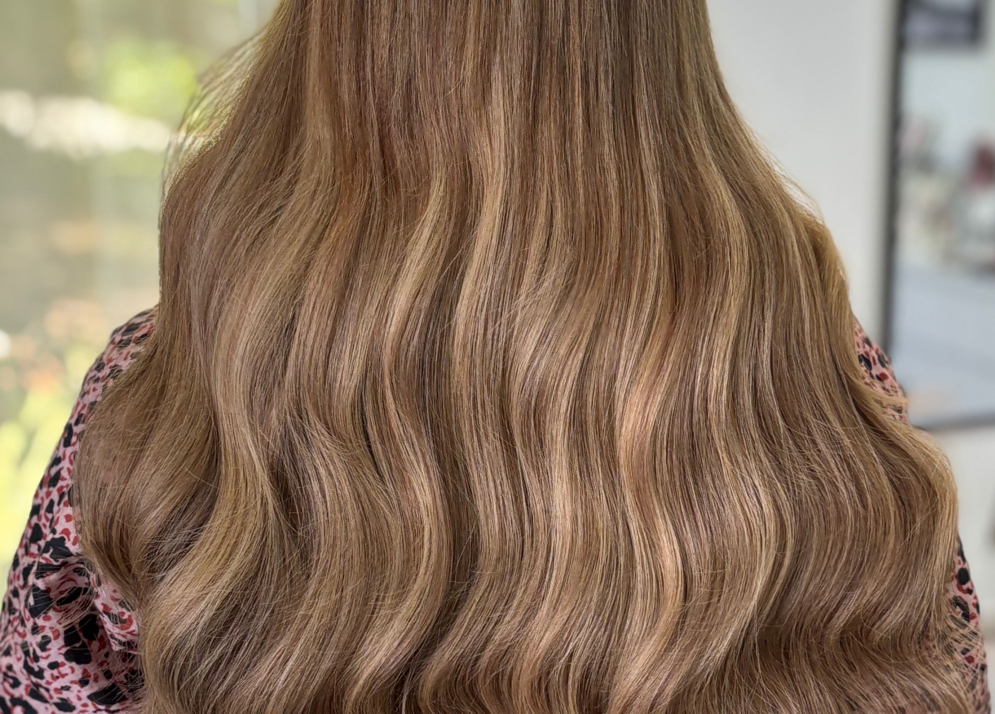 Long wavy brown hair styled at Deluxe Lash & Locks, West Wodonga, Victoria, AU.