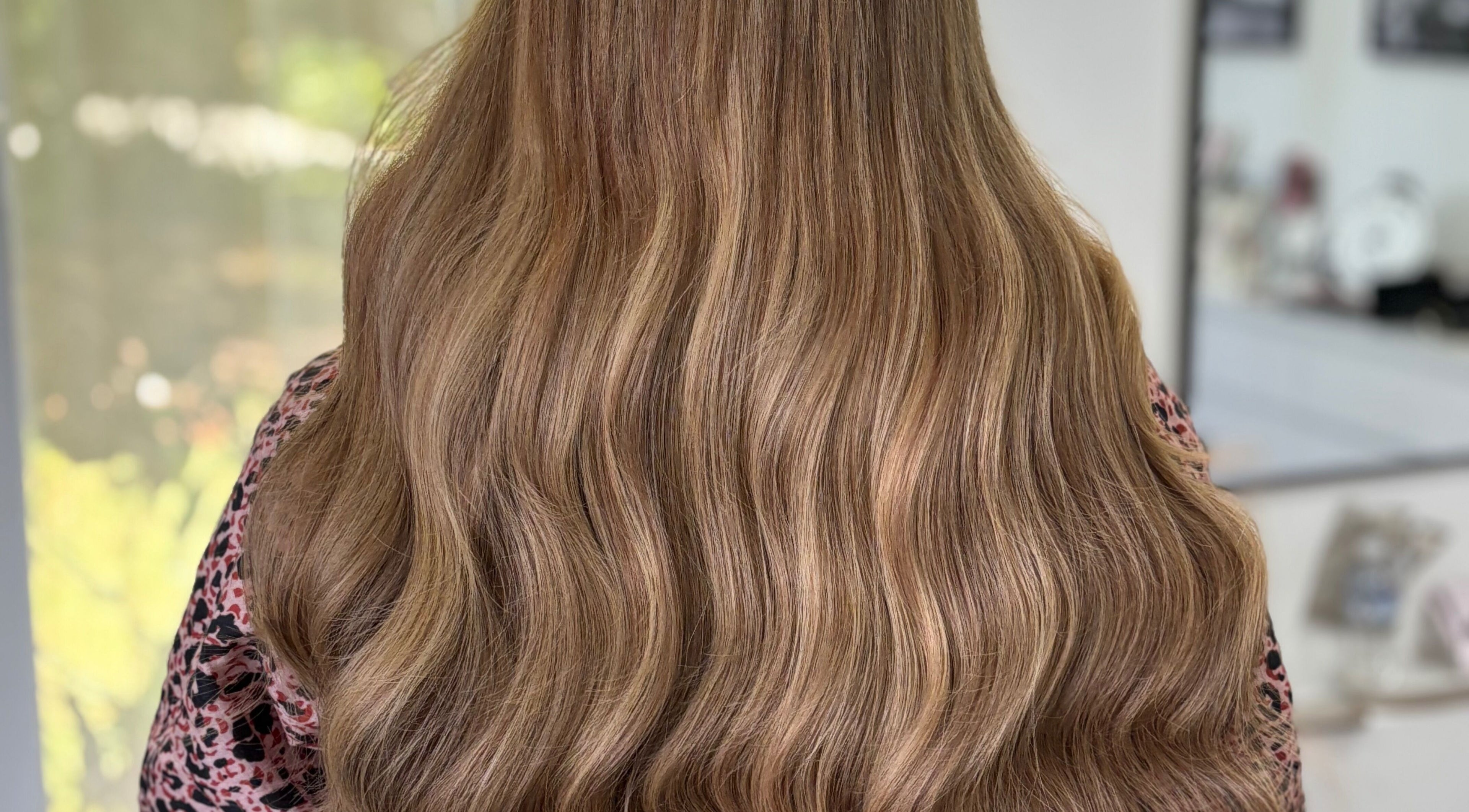 Long wavy brown hair styled at Deluxe Lash & Locks, West Wodonga, Victoria, AU.