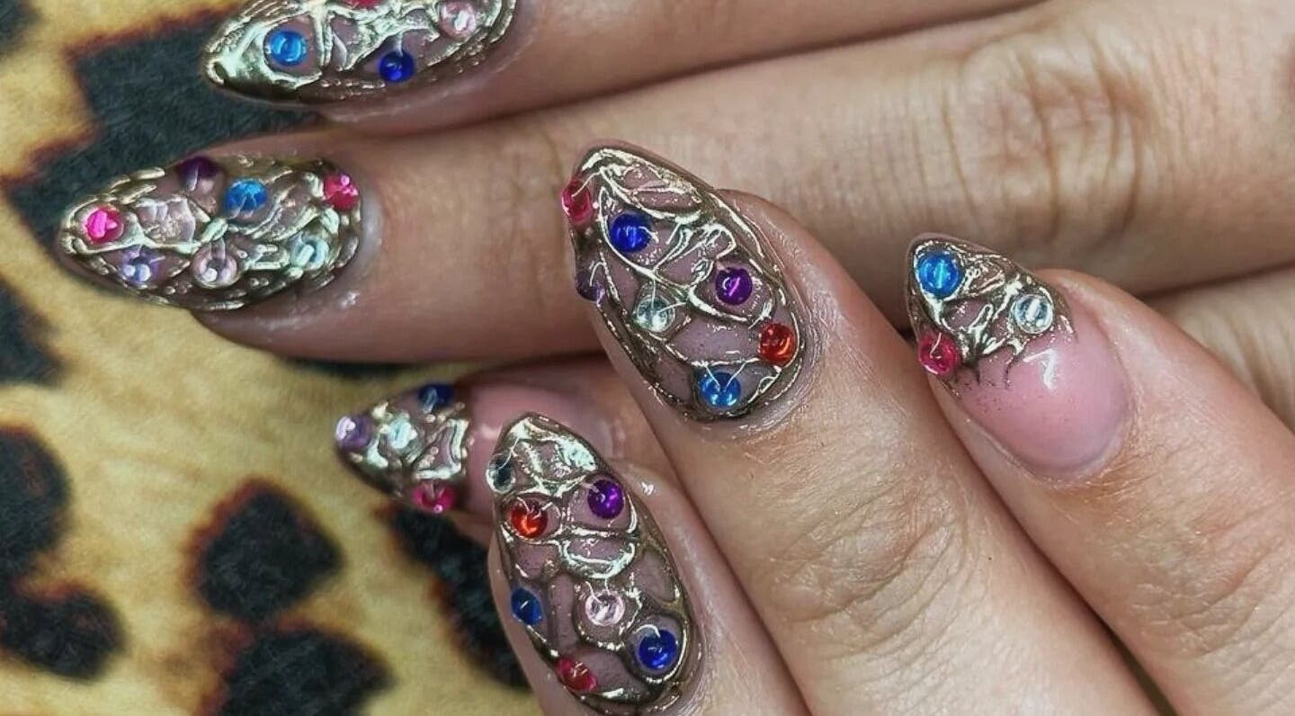Intricate jeweled nail art at Cute But Deadly nail co. Bathgate, Scotland, GB showcases vibrant colors and designs.