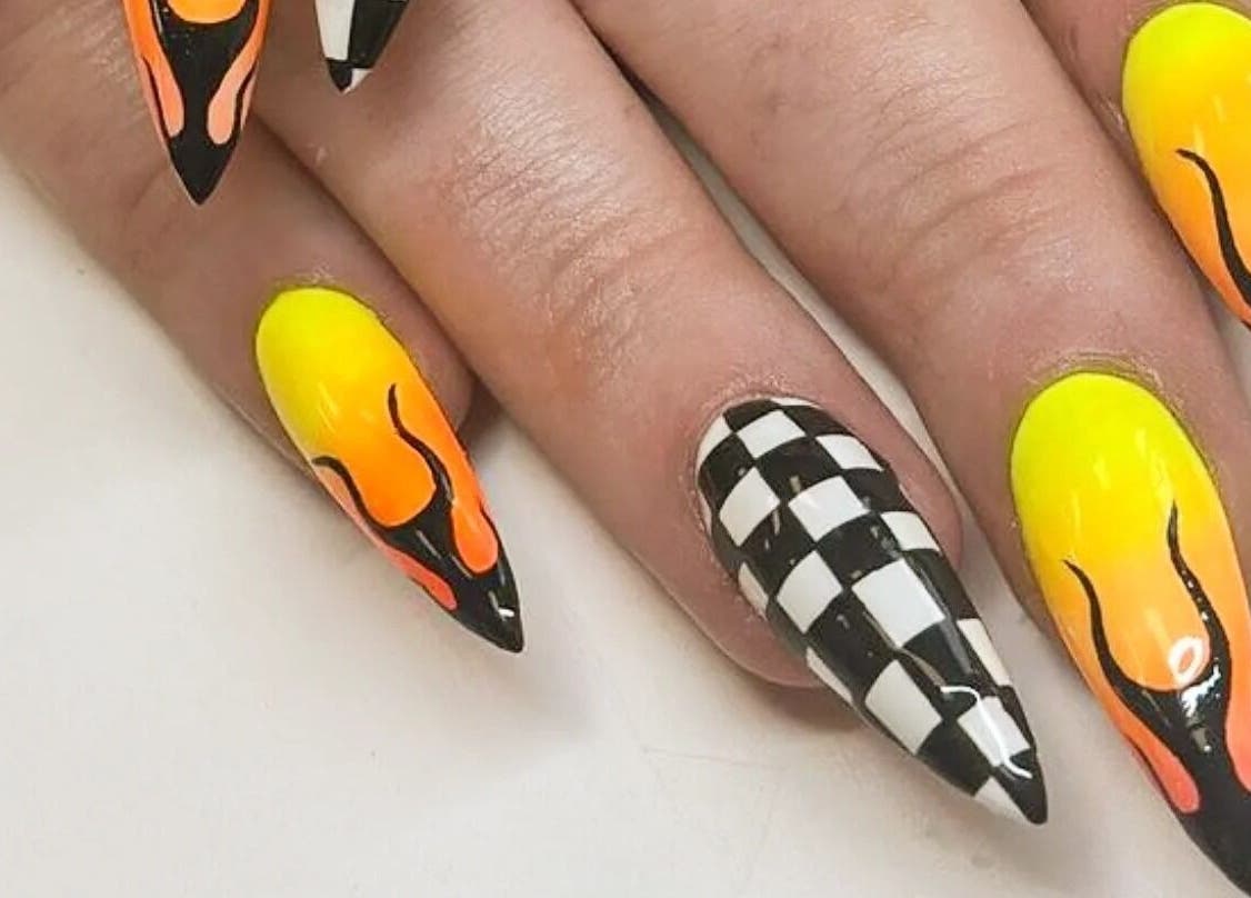 Vibrant flame and checkered nail design at Cute But Deadly nail co. Bathgate, in Bathgate, Scotland, GB.