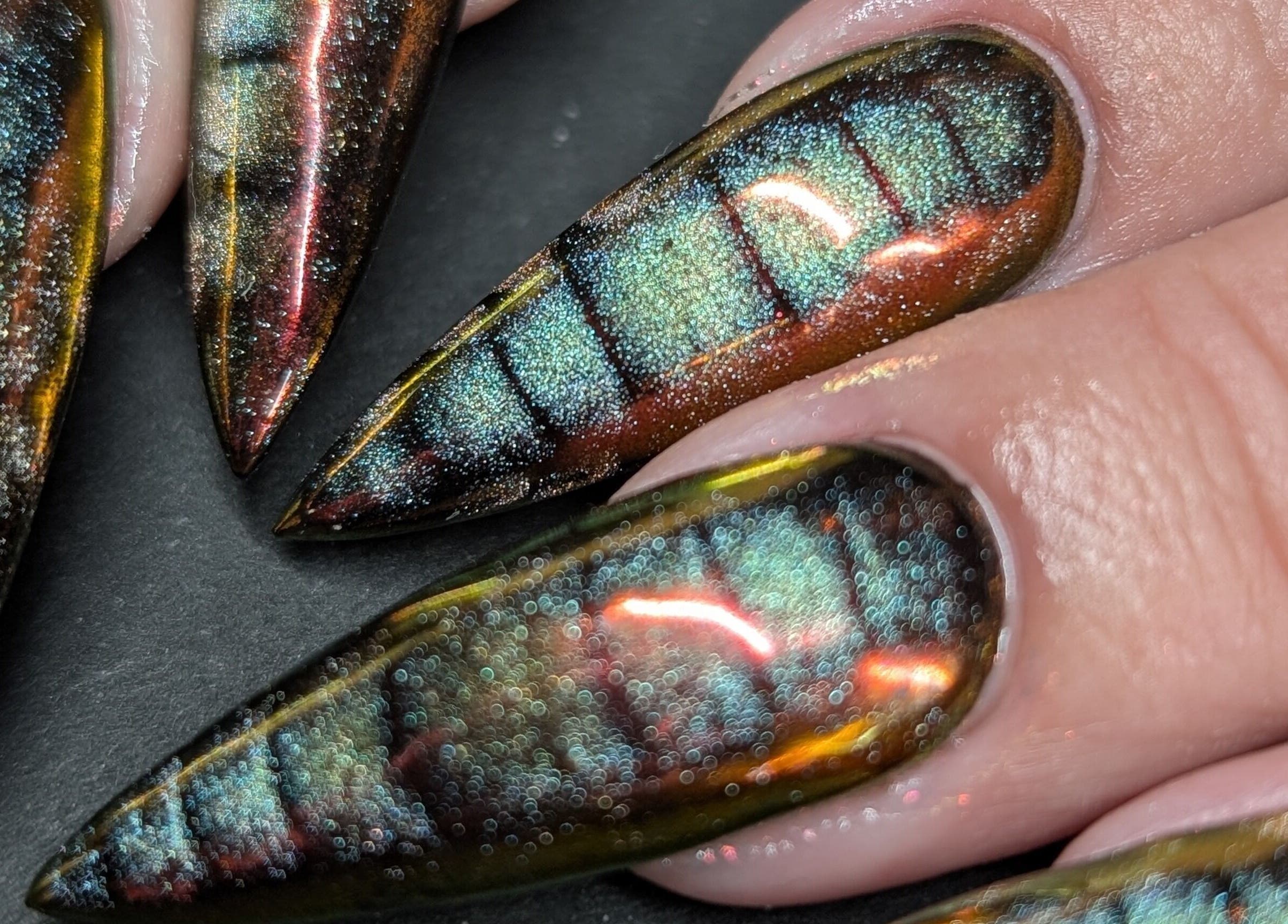 Iridescent nail art from Cute But Deadly nail co. Bathgate, Scotland, GB showcasing glossy, vibrant designs.