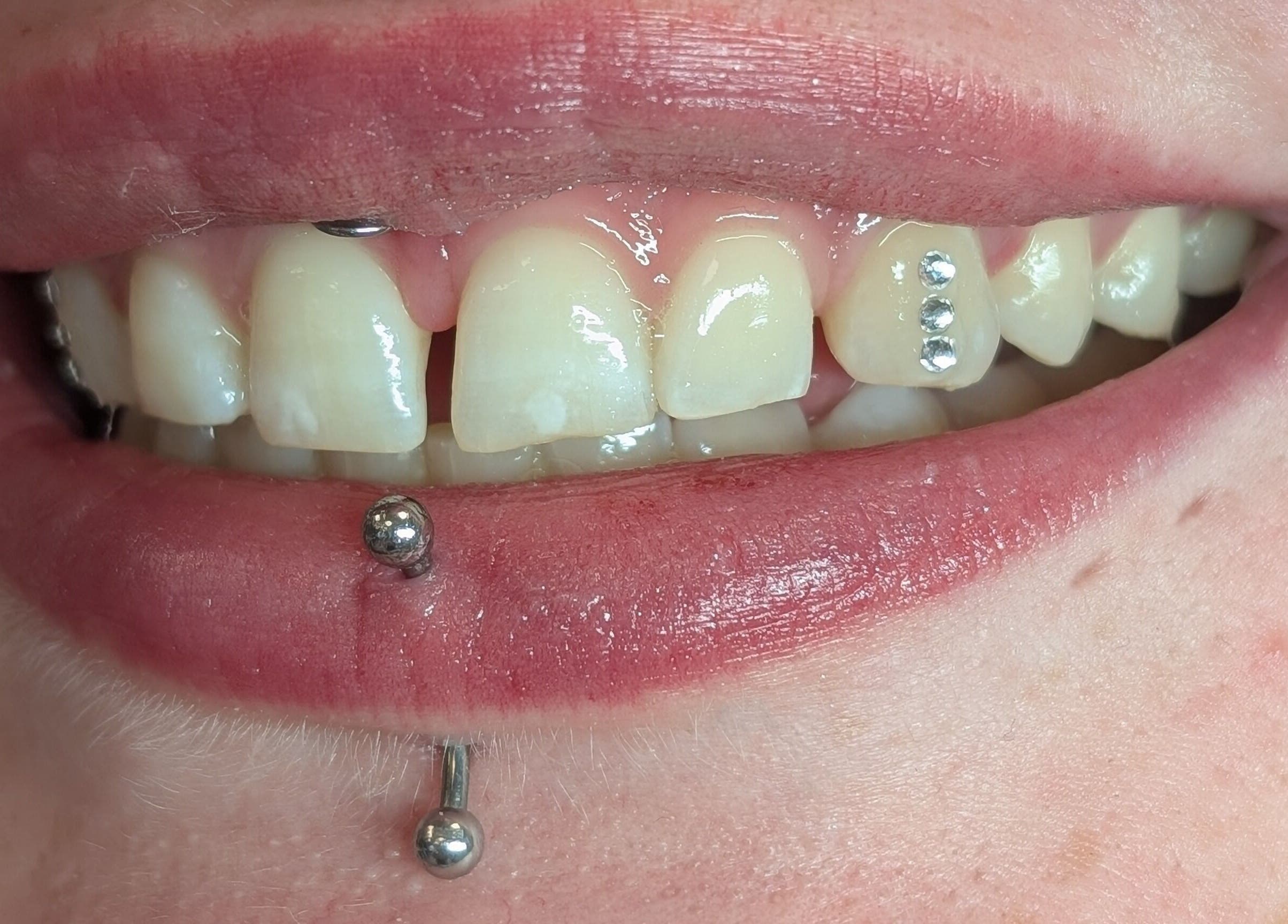 Decorative lip and tooth piercings at Cute But Deadly nail co. Bathgate, Scotland, GB.