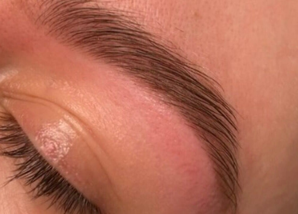 Expert brow shaping at Lashed by Linz, Basingstoke, England, GB enhances natural beauty.