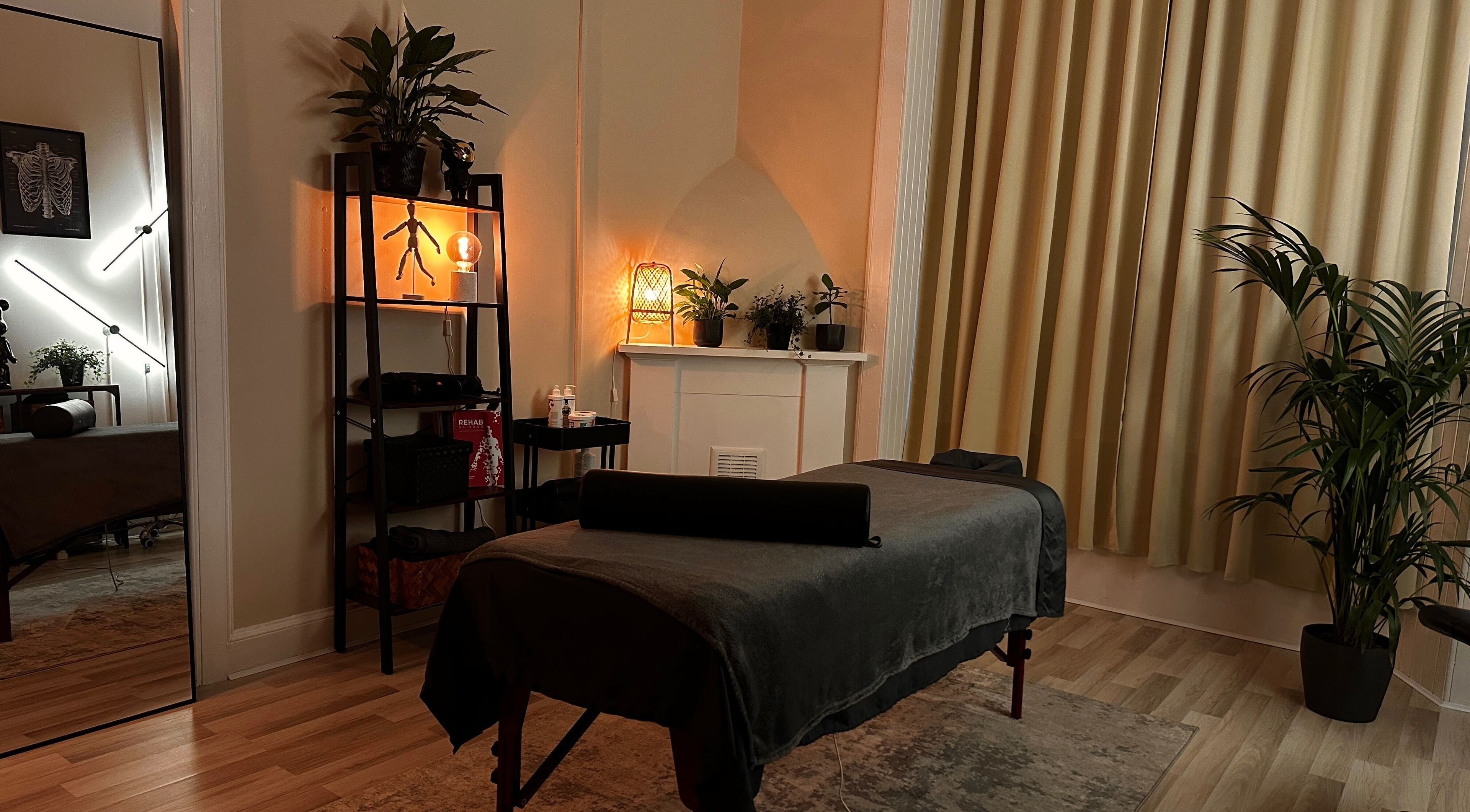 Relaxing massage room at KS Therapies, Glasgow, Scotland, GB with soft lighting and calming decor.