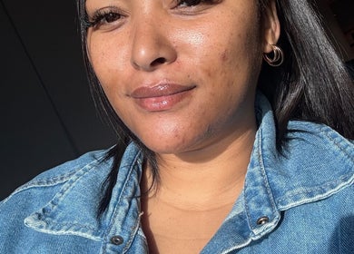 Smiling woman with glowing skin at Eyedolashes, Cape Town, Western Cape, ZA.