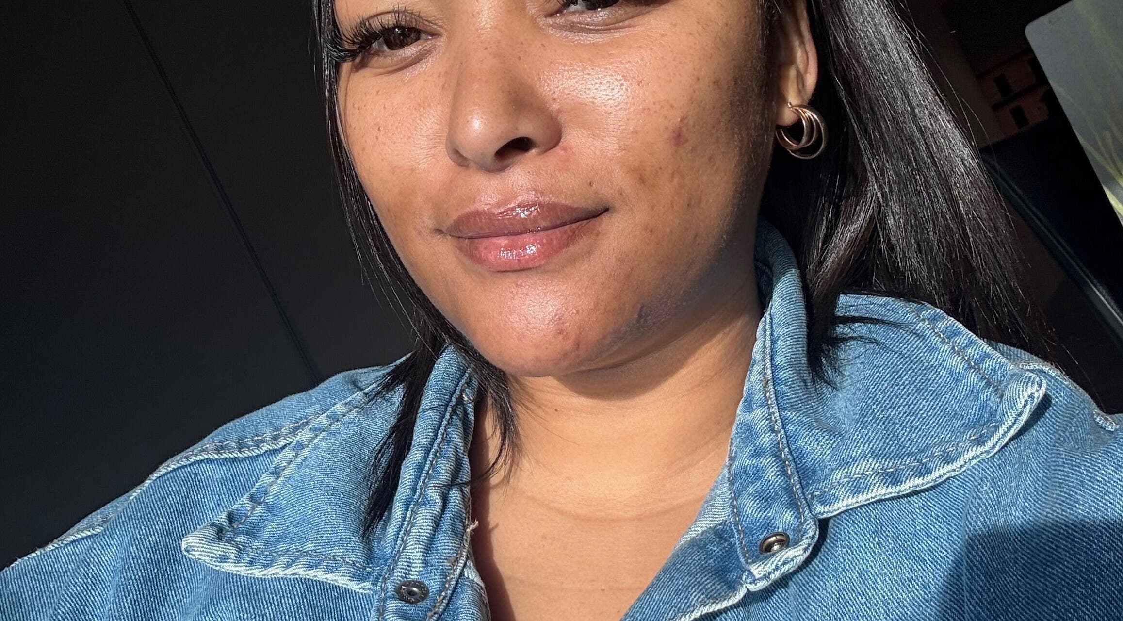 Smiling woman with glowing skin at Eyedolashes, Cape Town, Western Cape, ZA.