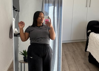 Woman taking selfie at Eyedolashes, Cape Town, Western Cape, ZA. Cozy room with modern decor.