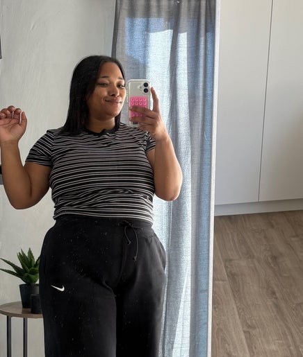 Woman taking selfie at Eyedolashes, Cape Town, Western Cape, ZA. Cozy room with modern decor.