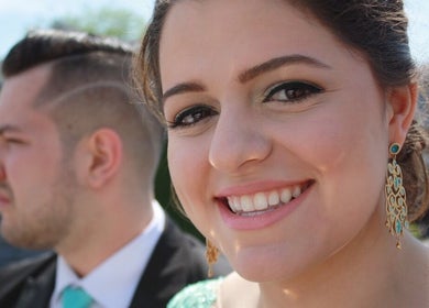 Smiling woman with elegant earrings at The Enchanted Beautician, Kincardine, Ontario, CA.