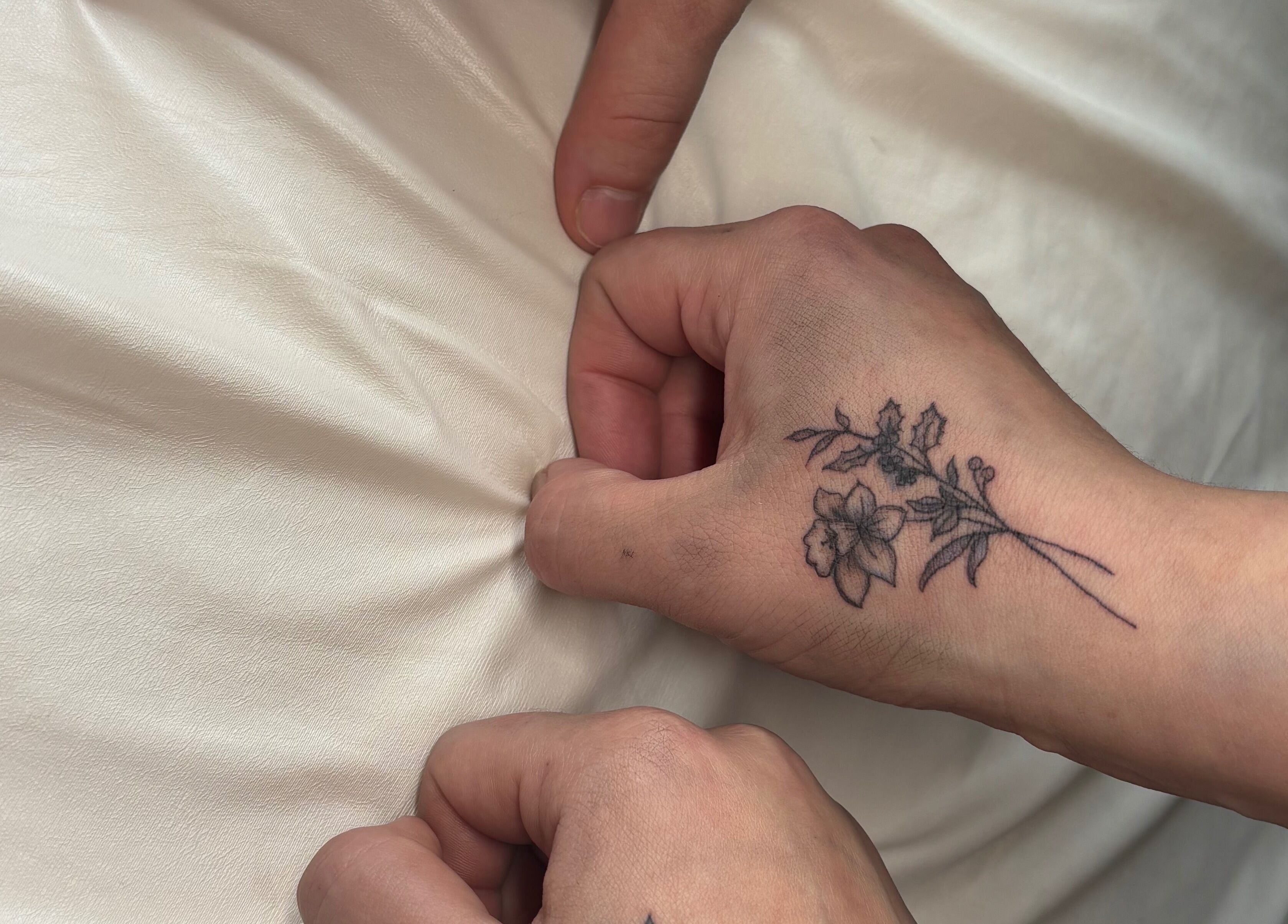 Floral tattoo design on hand at Longhorn Beauty Academy, Post Falls, Idaho, US.