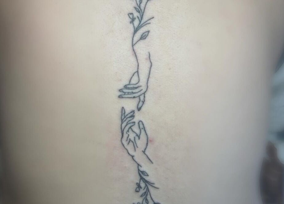 Intricate hand-themed tattoo design at Longhorn Beauty Academy, Post Falls, Idaho, US.