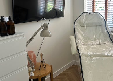 Tranquil treatment room at Jess Palmer Beauty, Bridgwater, England, GB with a sleek white chair and serene decor.