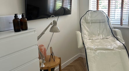 Tranquil treatment room at Jess Palmer Beauty, Bridgwater, England, GB with a sleek white chair and serene decor.