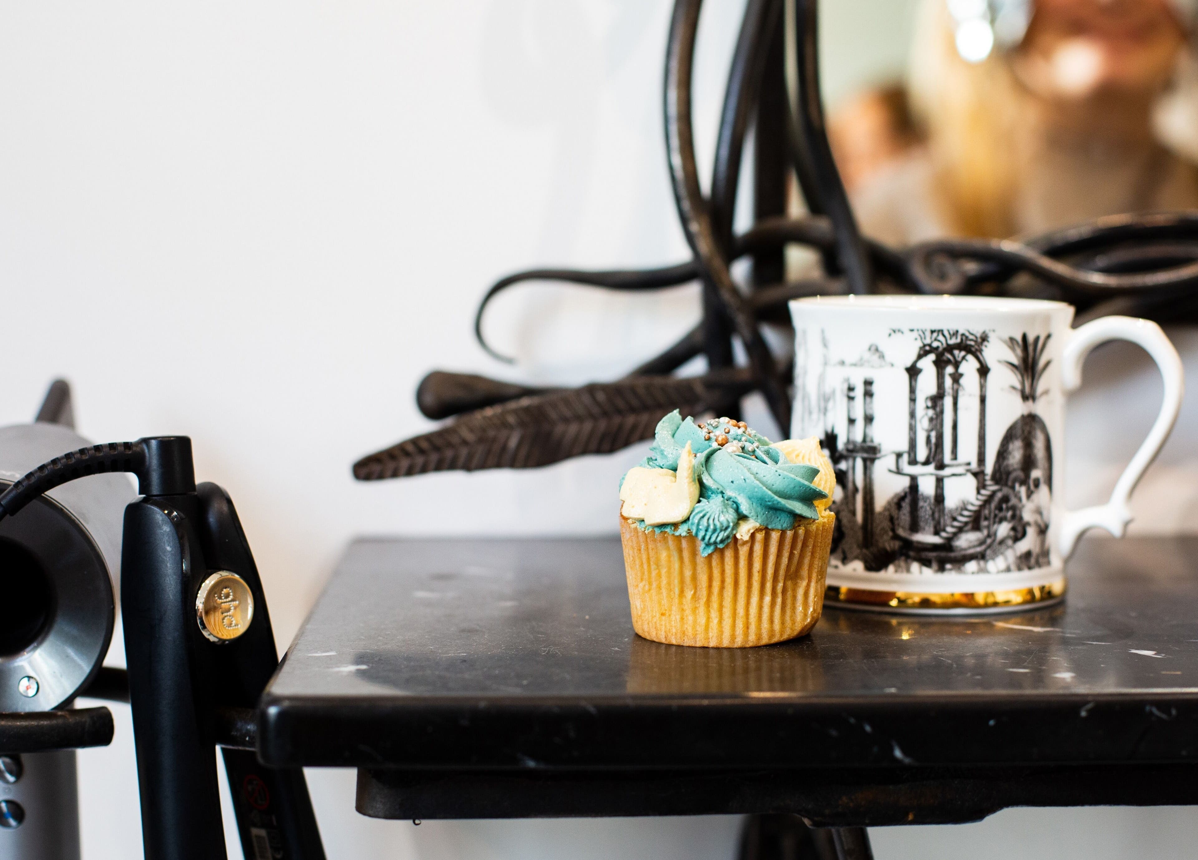 A chic salon scene at Tara’s Beautique, Bristol, England, GB featuring a cupcake and hairdryer.