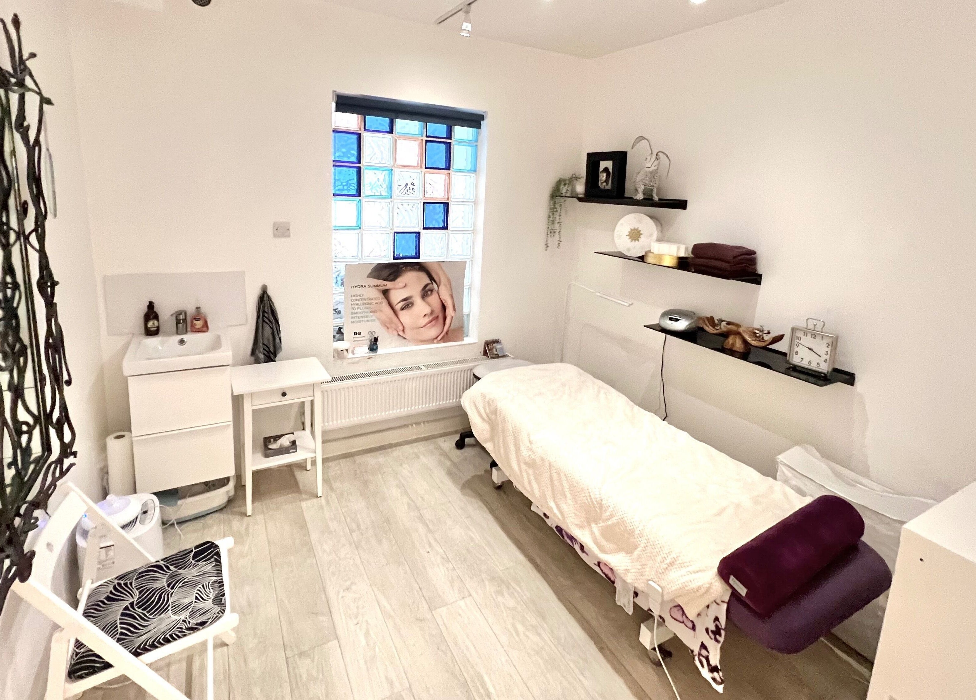 Calming treatment room at Tara’s Beautique, Bristol, England, GB, featuring a massage bed and elegant decor.