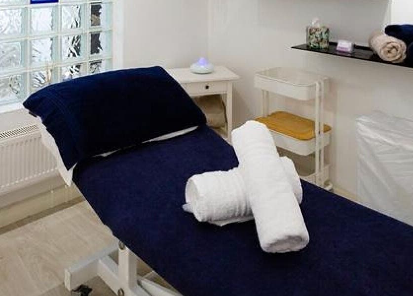 Comfortable treatment room at Tara’s Beautique, Bristol, England, GB, featuring a massage table and soft towels.