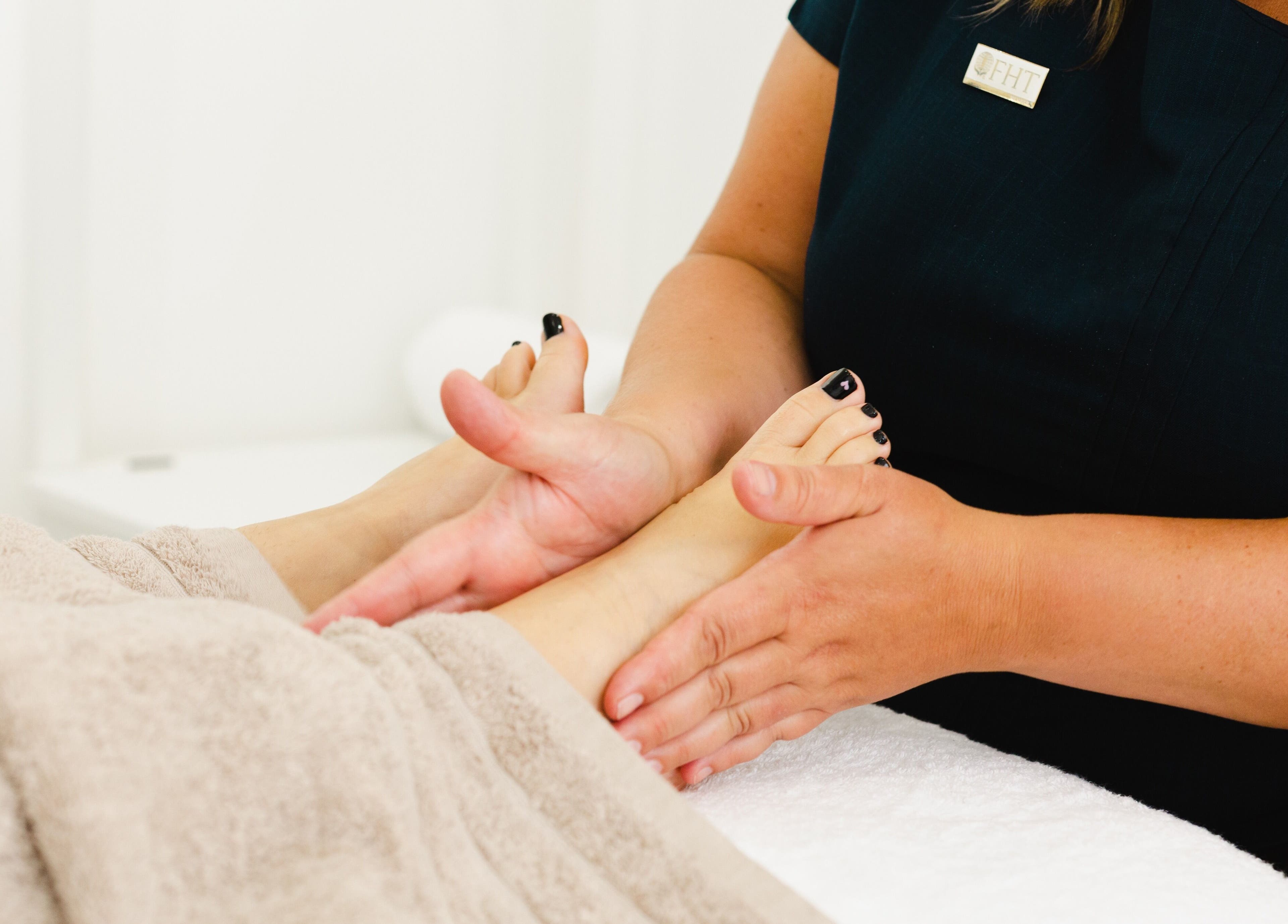 Therapist providing a soothing foot massage at Tara’s Beautique, Bristol, England, GB.