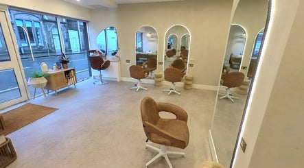 Chic interior of Outback Salon, Dunfermline, Scotland, GB with stylish mirrors and modern seating.