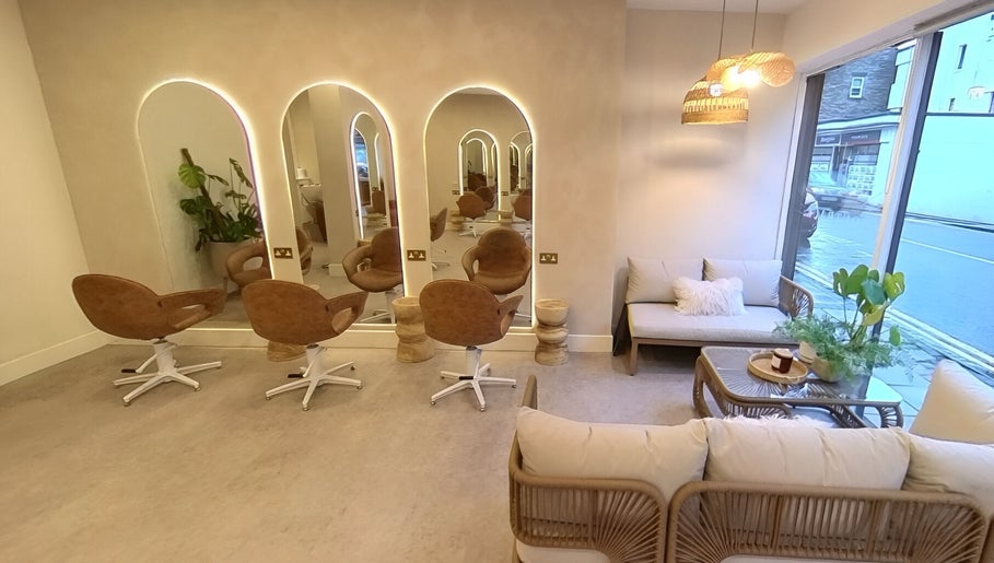 Stylish salon interior at Outback Salon, Dunfermline, Scotland, GB featuring modern chairs and cozy decor.