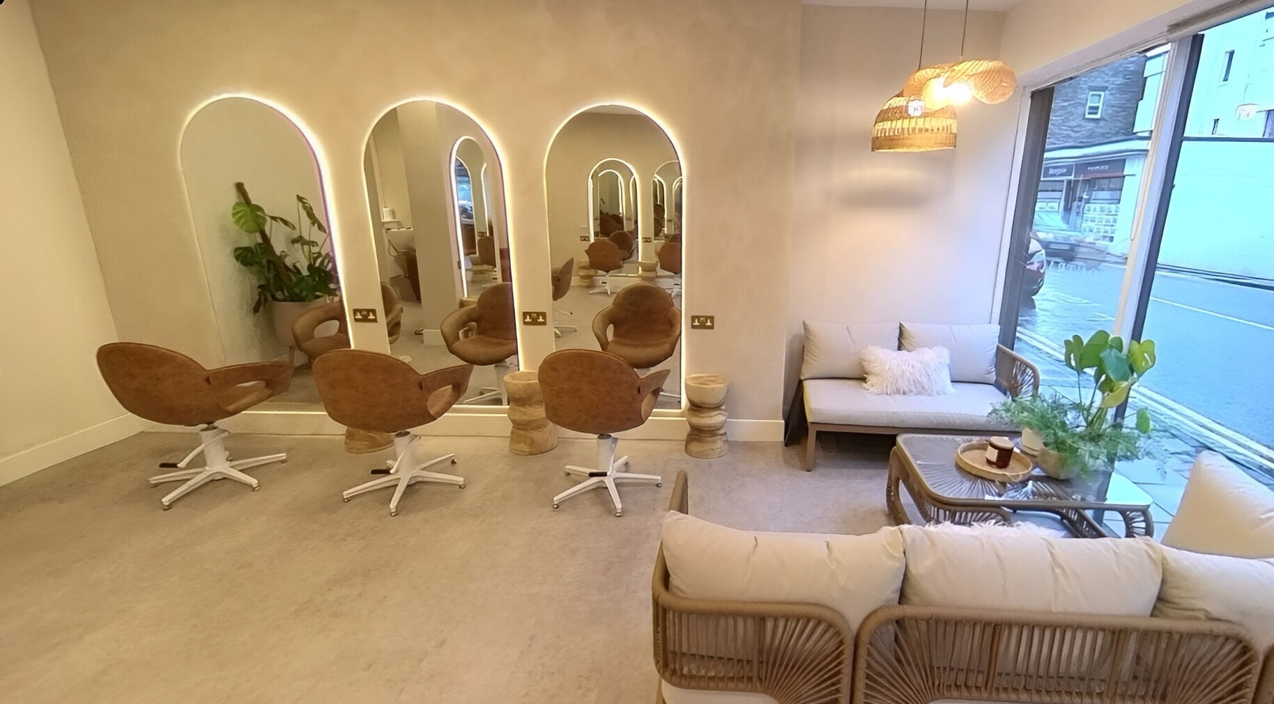 Stylish salon interior at Outback Salon, Dunfermline, Scotland, GB featuring modern chairs and cozy decor.