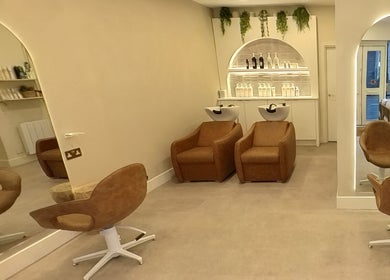 Modern salon chairs and sinks at Outback Salon in Dunfermline, Scotland, GB, showcasing a stylish and inviting setup.