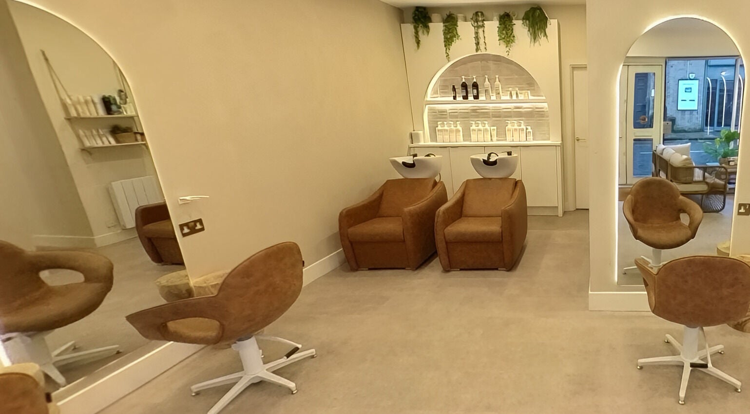 Modern salon chairs and sinks at Outback Salon in Dunfermline, Scotland, GB, showcasing a stylish and inviting setup.