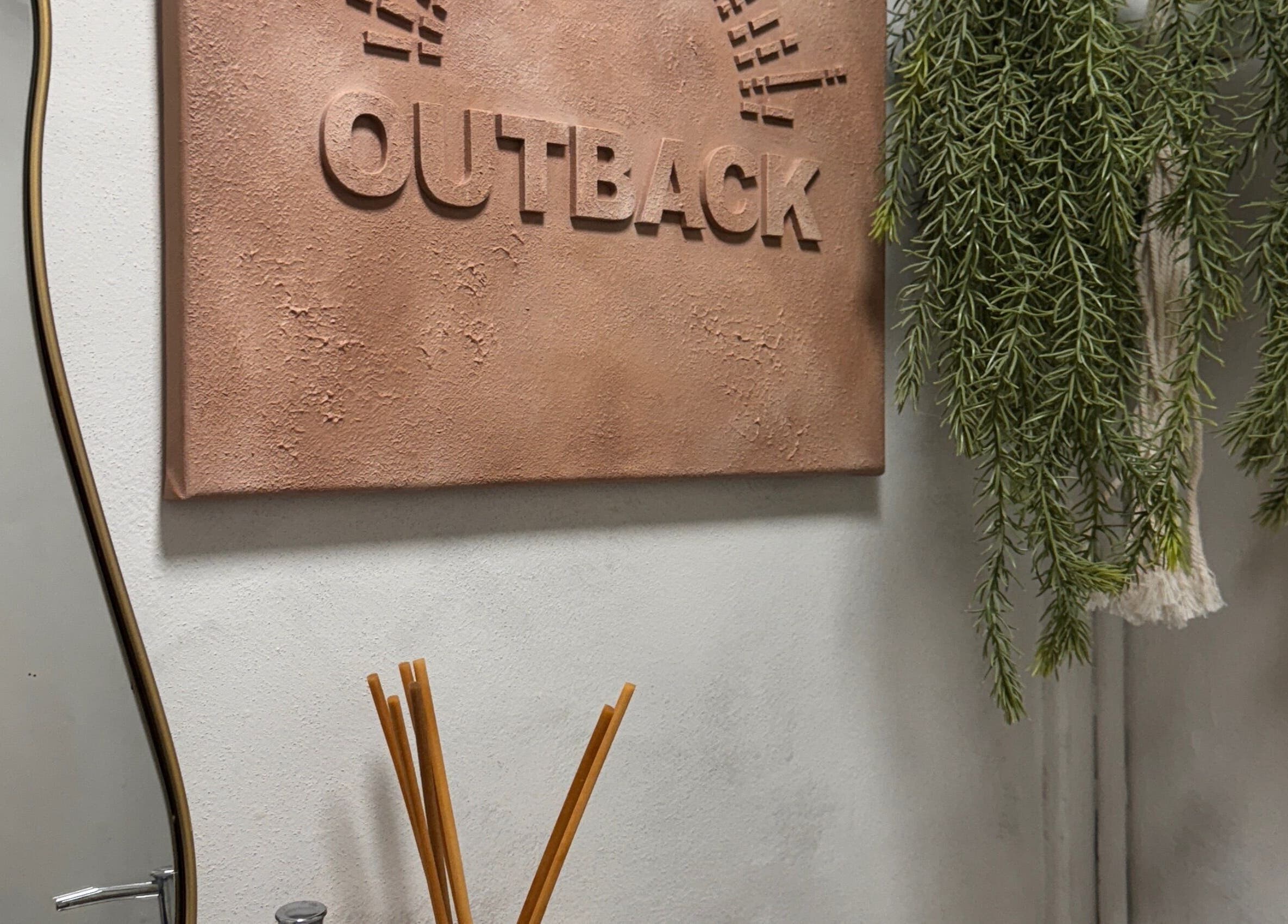 Outback Salon's rustic wall decor with greenery in Dunfermline, Scotland, GB, creating a serene atmosphere.