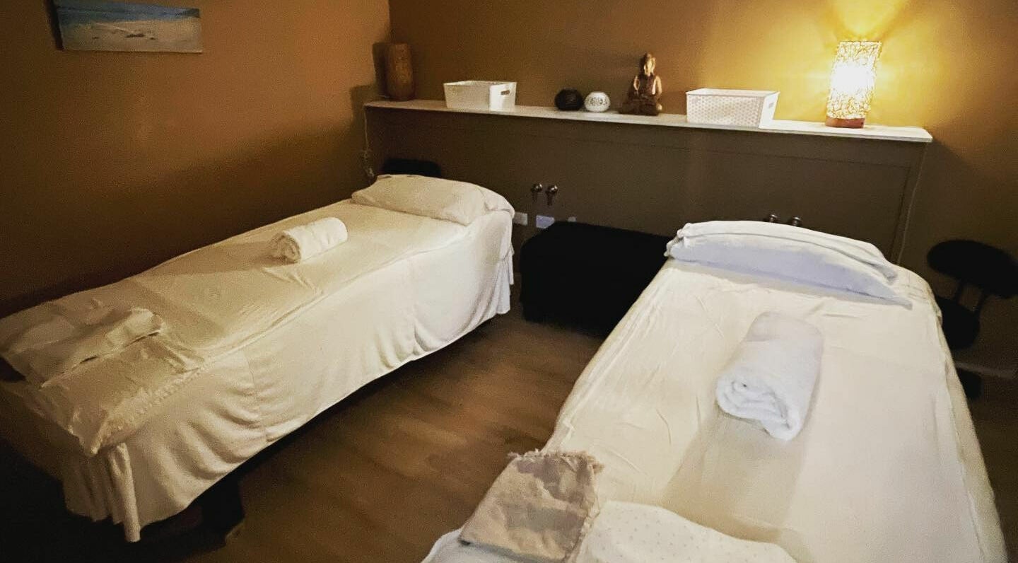 Tranquil massage room at Noosa Fair Massage, Noosa Heads, Queensland, AU, with two cozy beds.