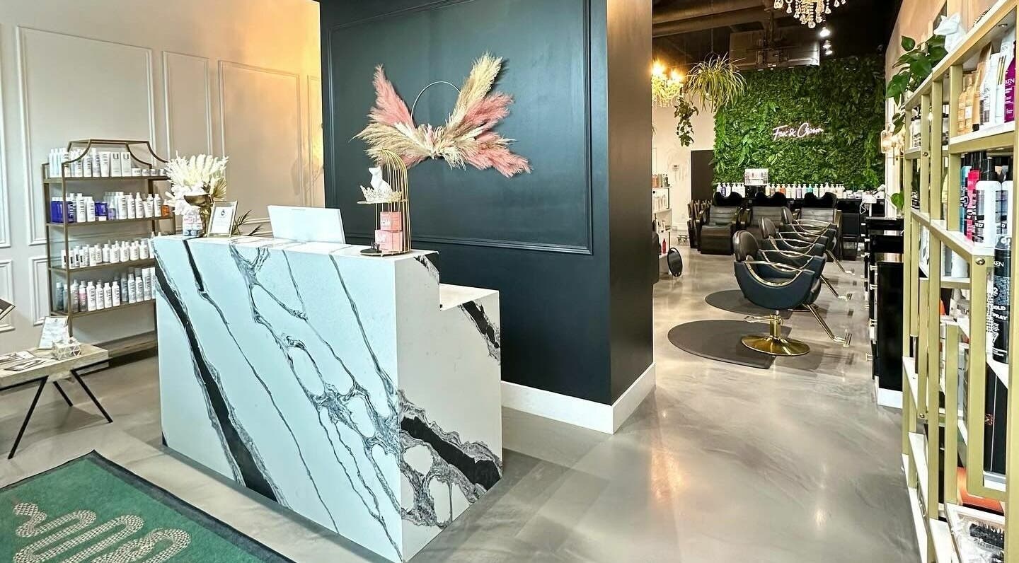 Stylish interior of Fox and Crown Hair Salon in Calgary, Alberta, CA showcasing elegant decor and seating area.