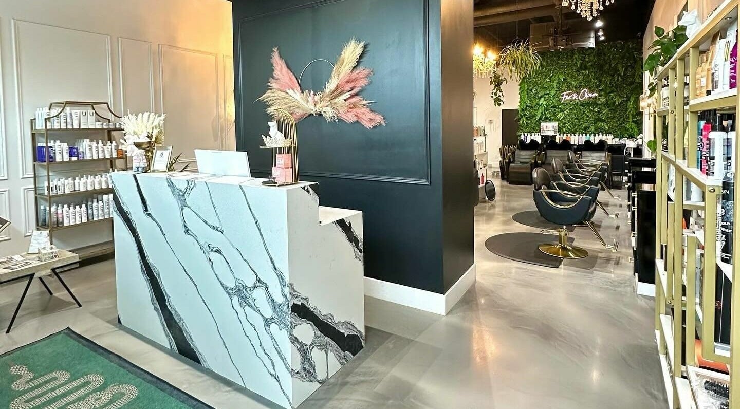 Stylish interior of Fox and Crown Hair Salon in Calgary, Alberta, CA showcasing elegant decor and seating area.