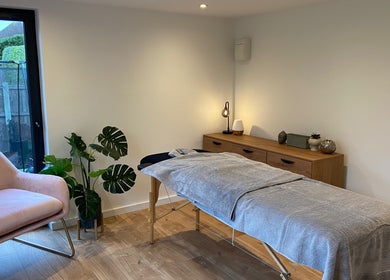 Tranquil massage room at The Retreat Room, Southend-on-sea, England, GB, featuring cozy chair and treatment bed.