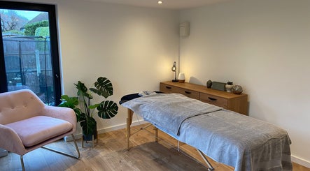 Tranquil massage room at The Retreat Room, Southend-on-sea, England, GB, featuring cozy chair and treatment bed.
