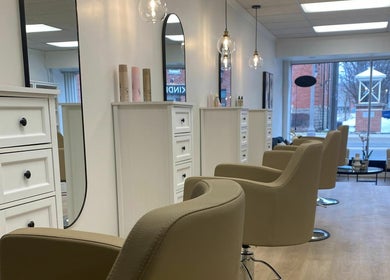 Chic salon interior at Blonde Design Co., Mount Forest, Ontario, CA with modern chairs and elegant decor.