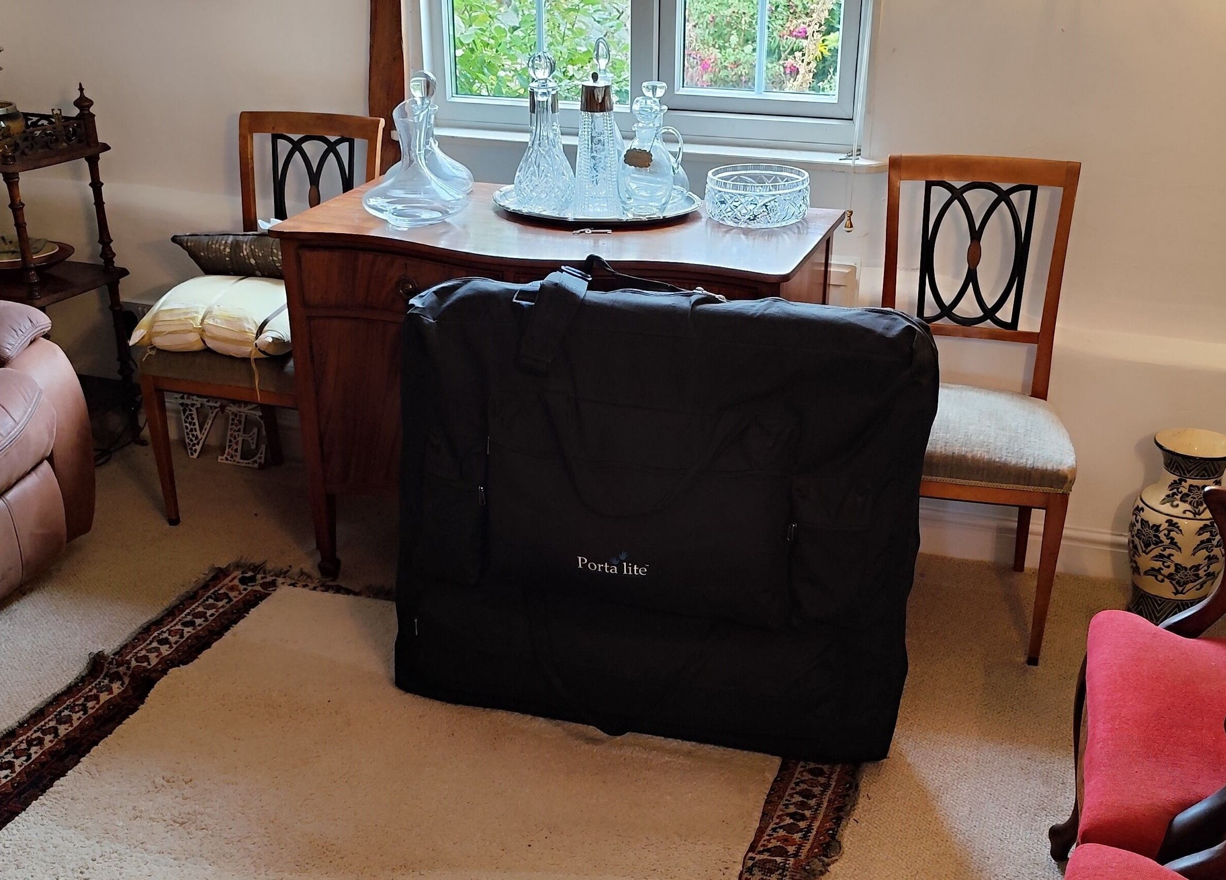 Cozy living room setup for MP's Mobile Massages in Ipswich, GB with massage equipment and classic decor.