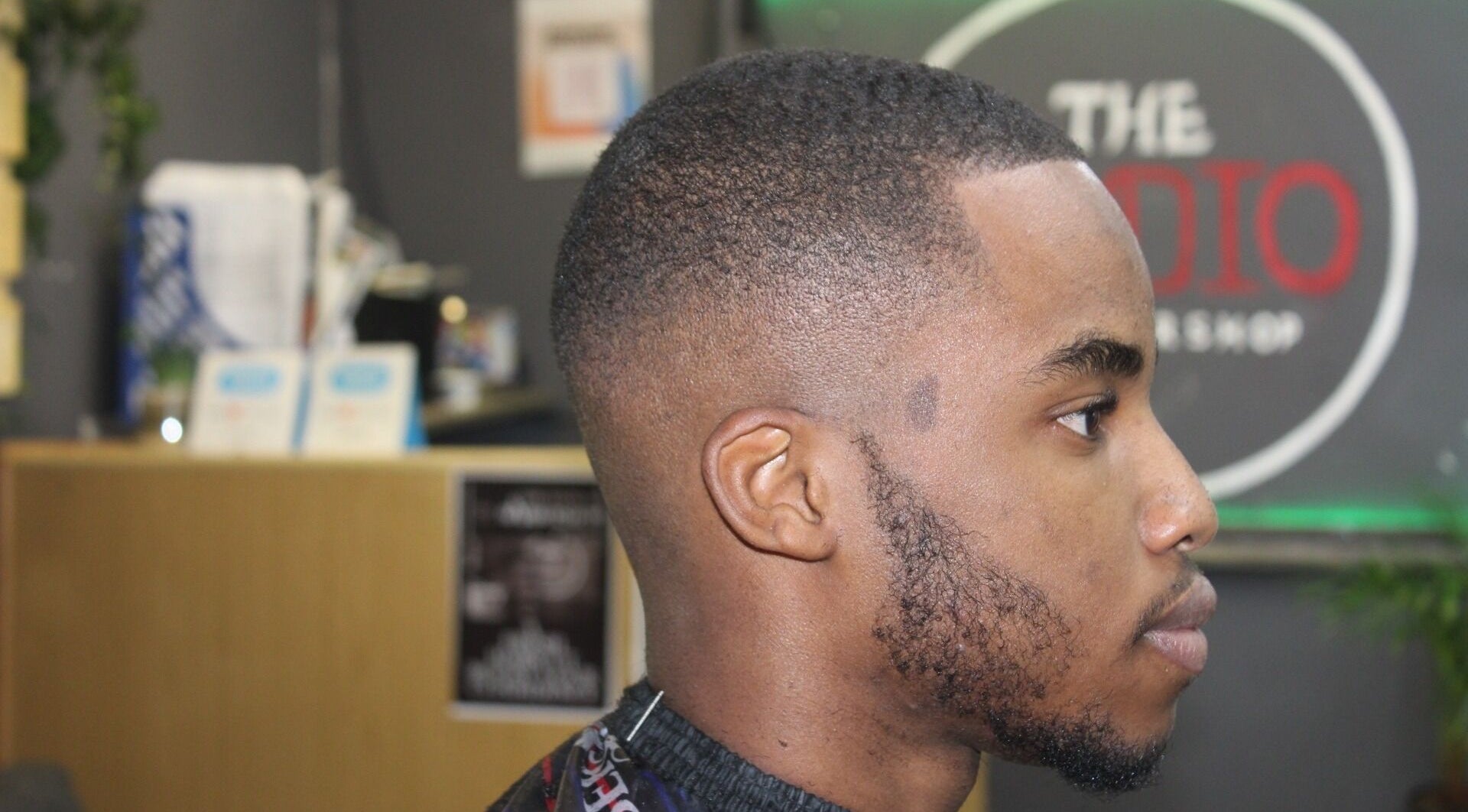 Client with a clean fade haircut at The Studio Barbershop, Cape Town, Western Cape, ZA showcasing expert styling.