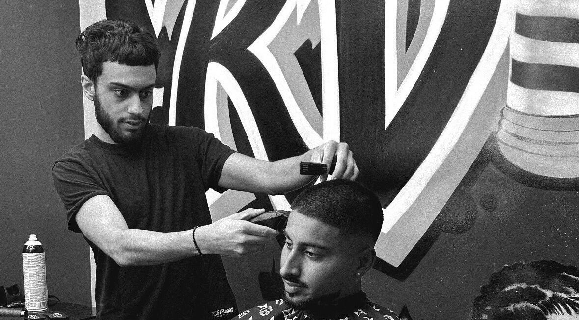 Expert barber at Kd.Cutzz, Surrey, BC, performing a detailed haircut with precision and style.