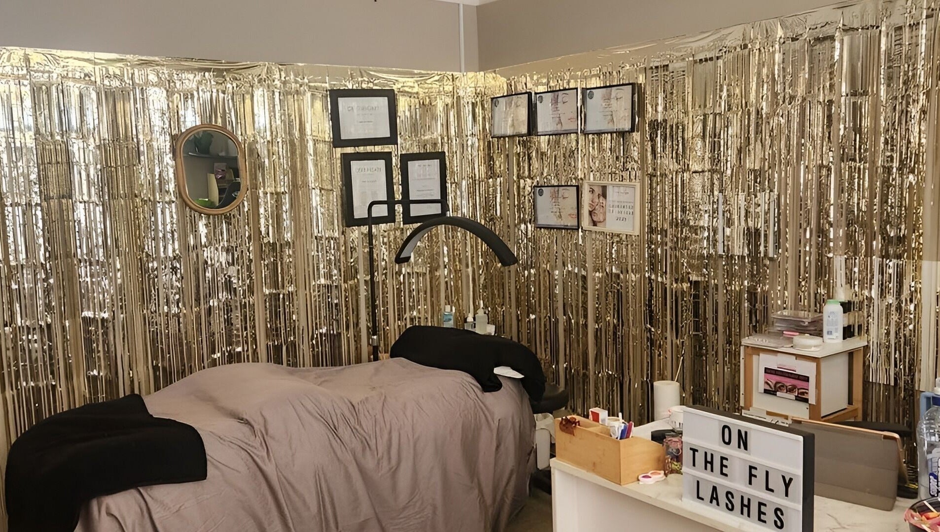 Chic lash room at On The Fly Lashes, Latrobe, Tasmania, AU with shimmering gold decor and cozy treatment area.