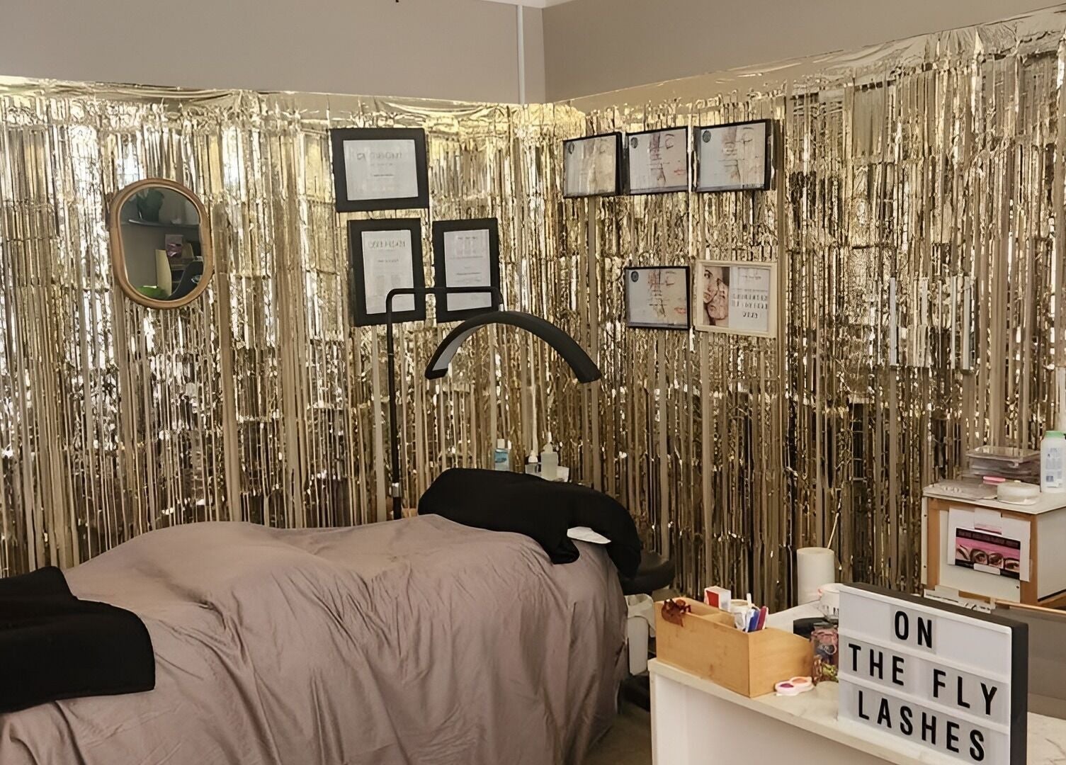 Chic lash room at On The Fly Lashes, Latrobe, Tasmania, AU with shimmering gold decor and cozy treatment area.