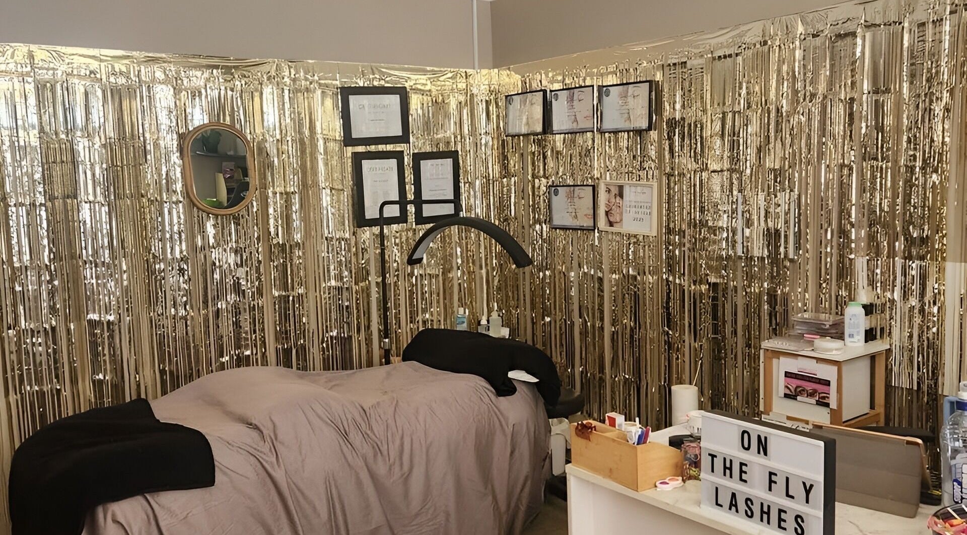 Chic lash room at On The Fly Lashes, Latrobe, Tasmania, AU with shimmering gold decor and cozy treatment area.