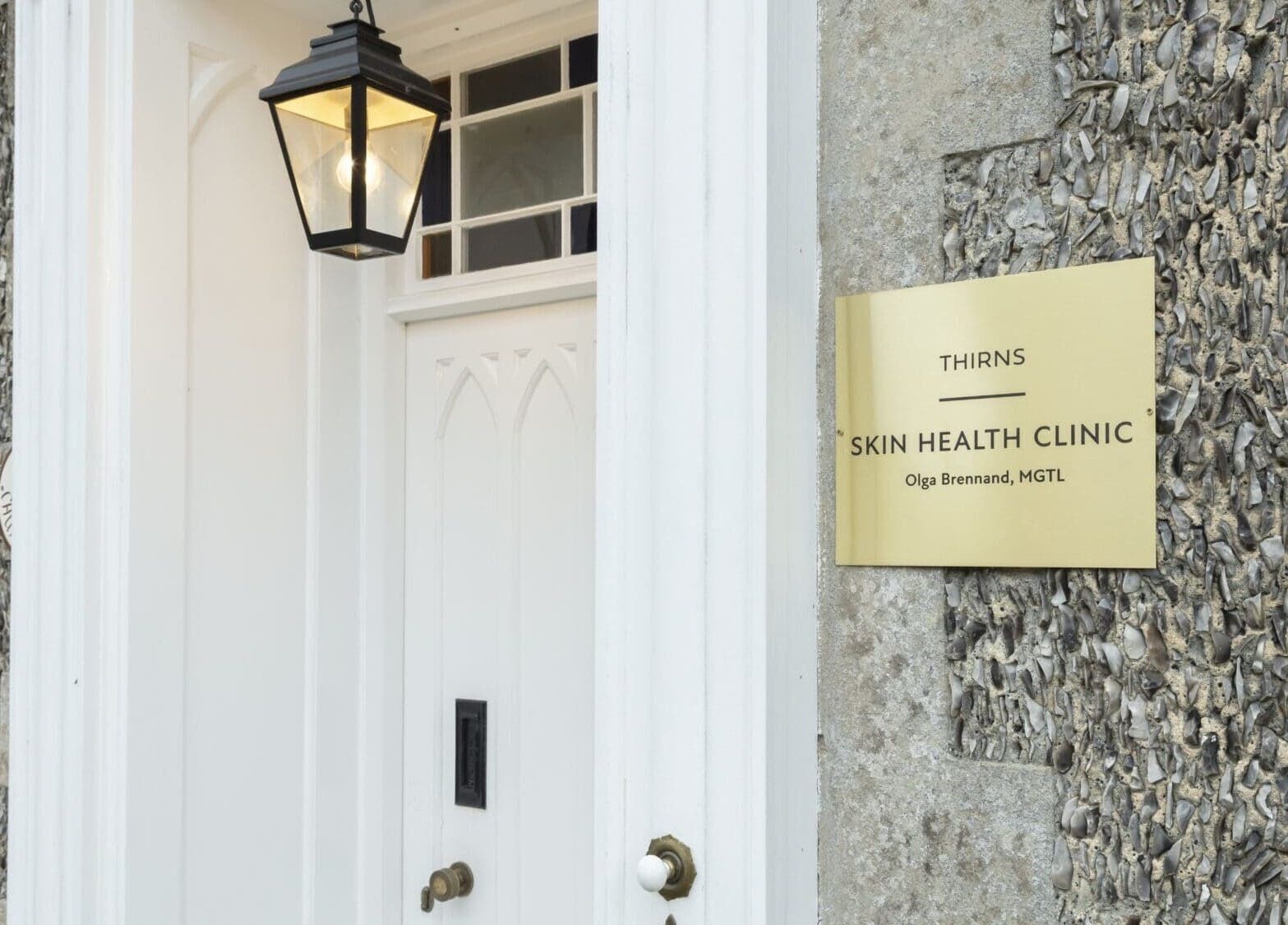 Elegant entrance to Thirns clinic in Bath, England, GB, featuring a golden sign and stylish lantern.