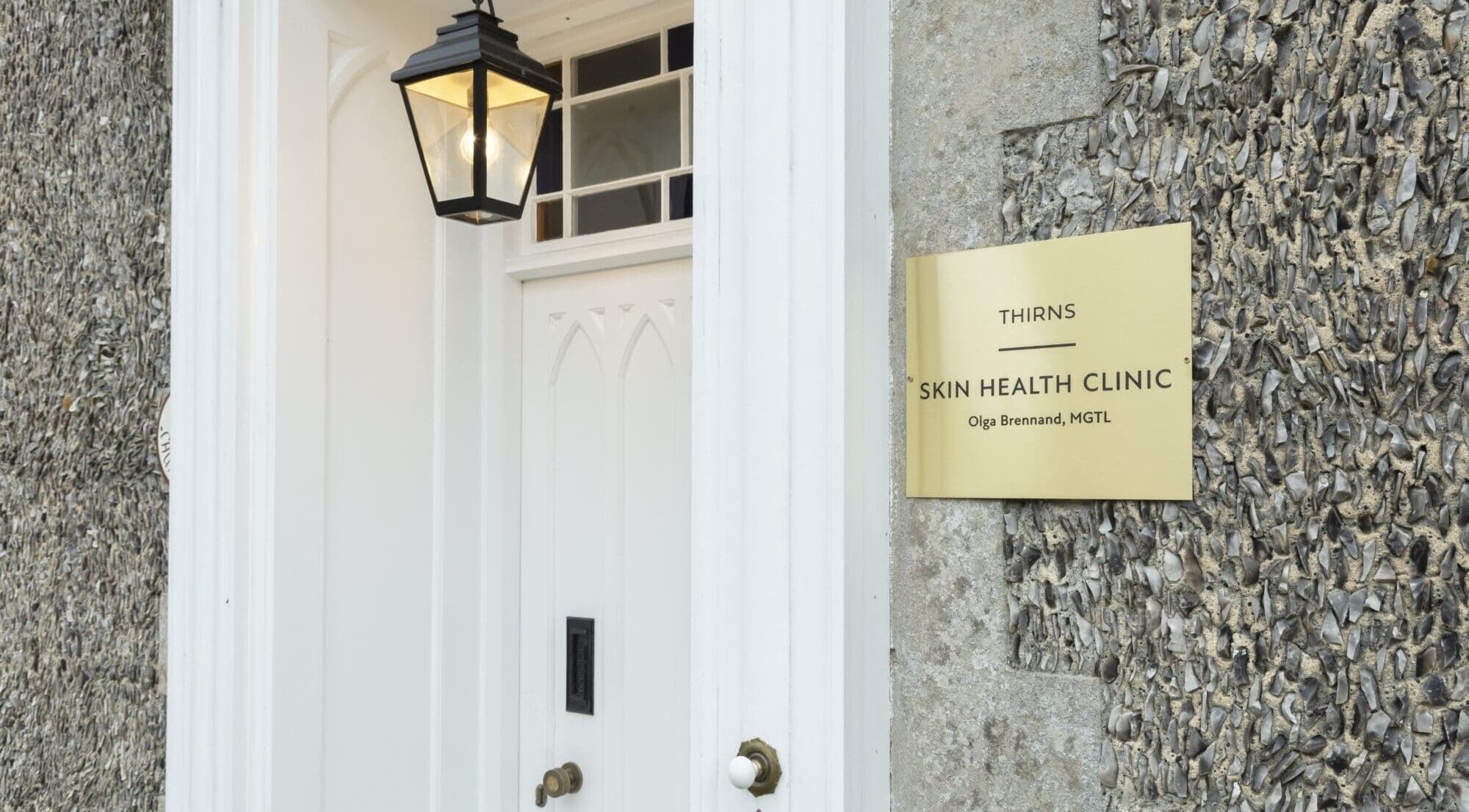 Elegant entrance to Thirns clinic in Bath, England, GB, featuring a golden sign and stylish lantern.