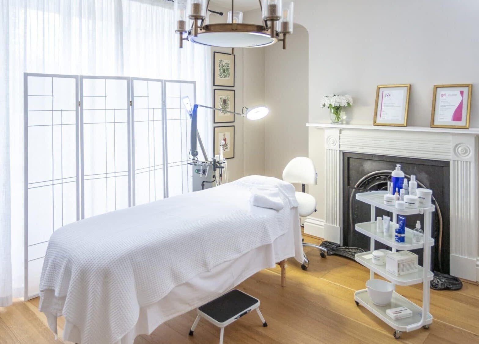 Relaxing spa room at Thirns in Bath, England, GB with massage table, serene decor, and professional skincare products.