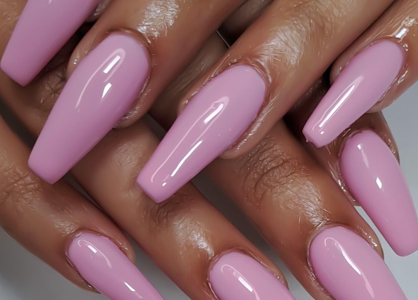 Glossy pink nails manicured at Minx nails & beauty, Cape Town, Western Cape, ZA. Stylish and elegant design.